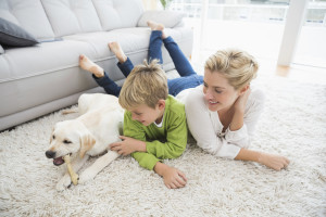 Happy mother and son with puppy
